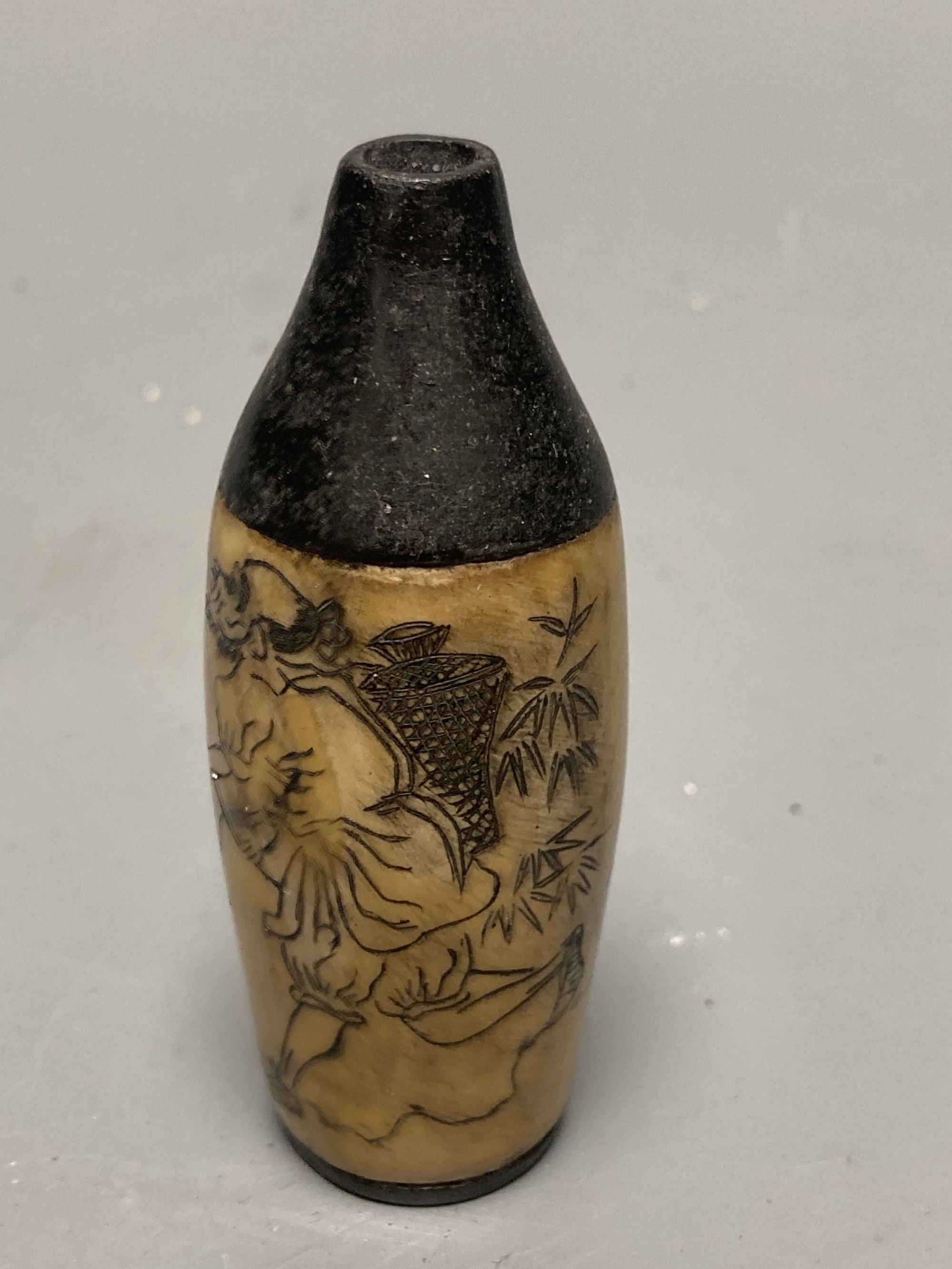 Two Chinese snuff bottles, one with erotic carving, tallest 7cm